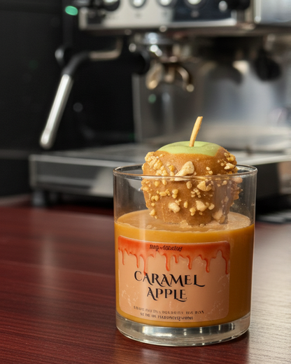 Caramel apple candle in a glass jar with an espresso machine in the background